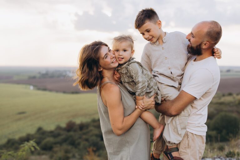 Happy Family Enjoying Time Together in Nature at Sunset