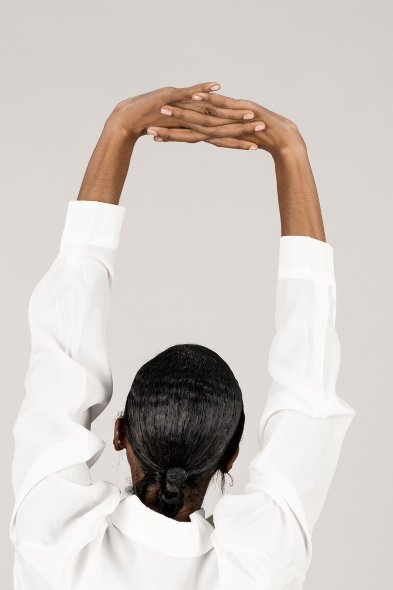 Black woman stretching her back muscles