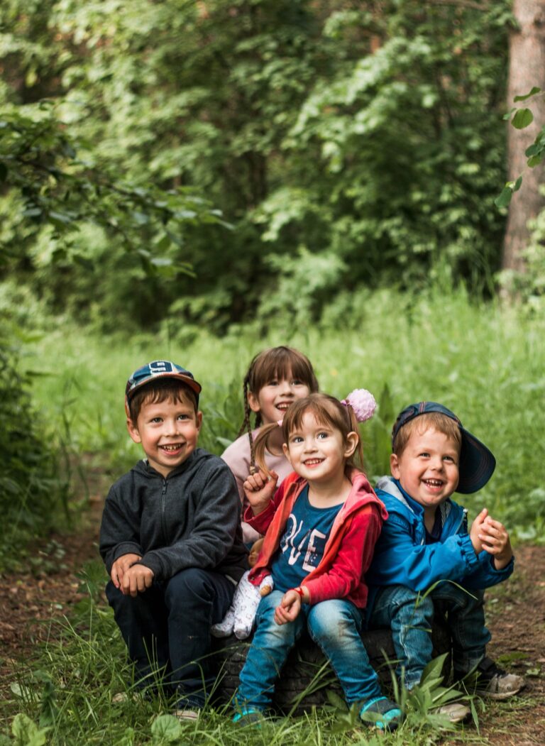 happy children sit on the street. The company of smiling children